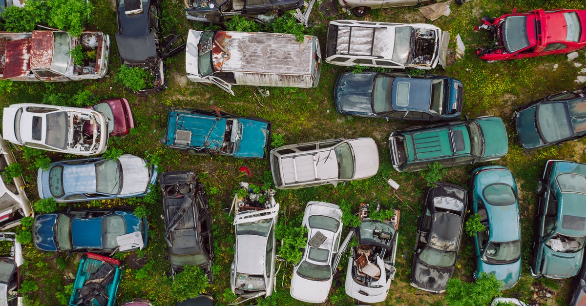 Best location for car rental when heading into/out of North Wales from London? - Car dump located on greenery in summer day Best location for car rental when heading into/out of North Wales from London? - Car dump located on greenery in summer day