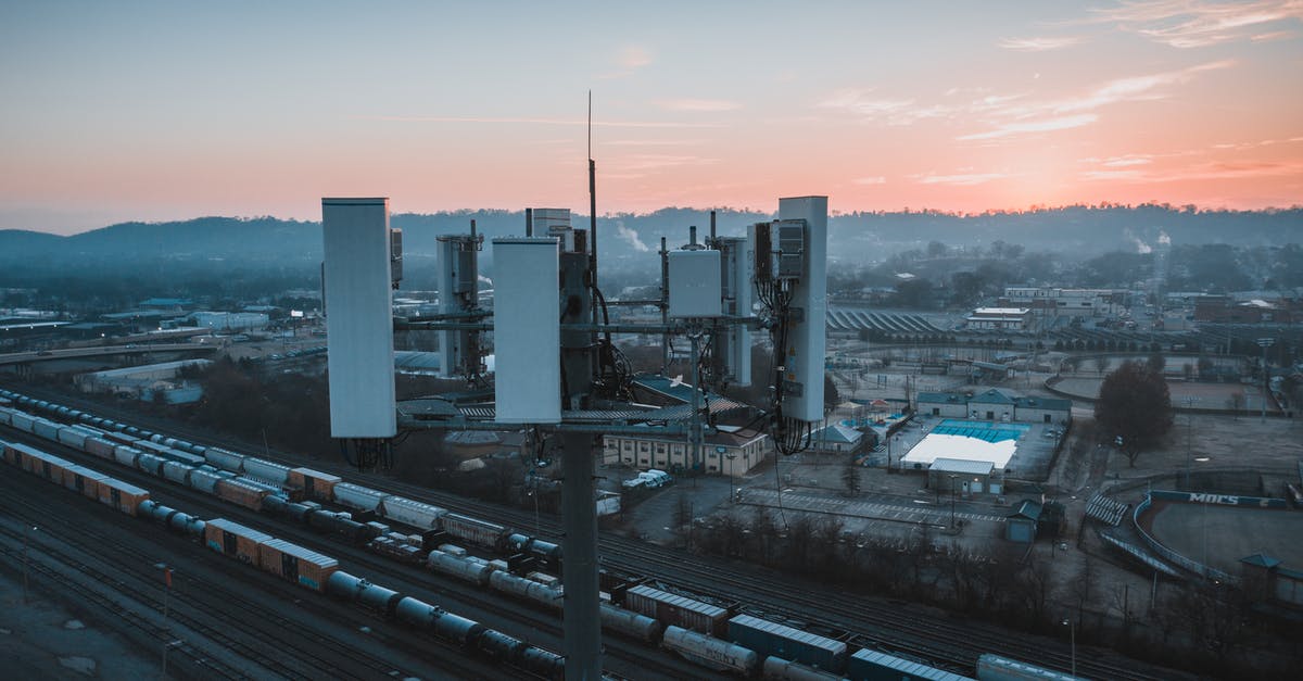 Best source to keep track of US floods? - Drone view of contemporary cell tower located near railway tracks with cargo containers and wagons against sunset sky Best source to keep track of US floods? - Drone view of contemporary cell tower located near railway tracks with cargo containers and wagons against sunset sky