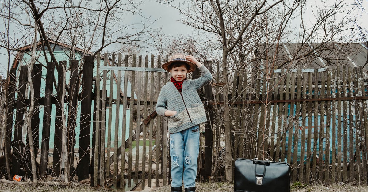 Best strategy for UK visa for a school trip (travelling alone or accomanpied child)? - Cheerful child traveler standing on rural path near fence of old cottage Best strategy for UK visa for a school trip (travelling alone or accomanpied child)? - Cheerful child traveler standing on rural path near fence of old cottage
