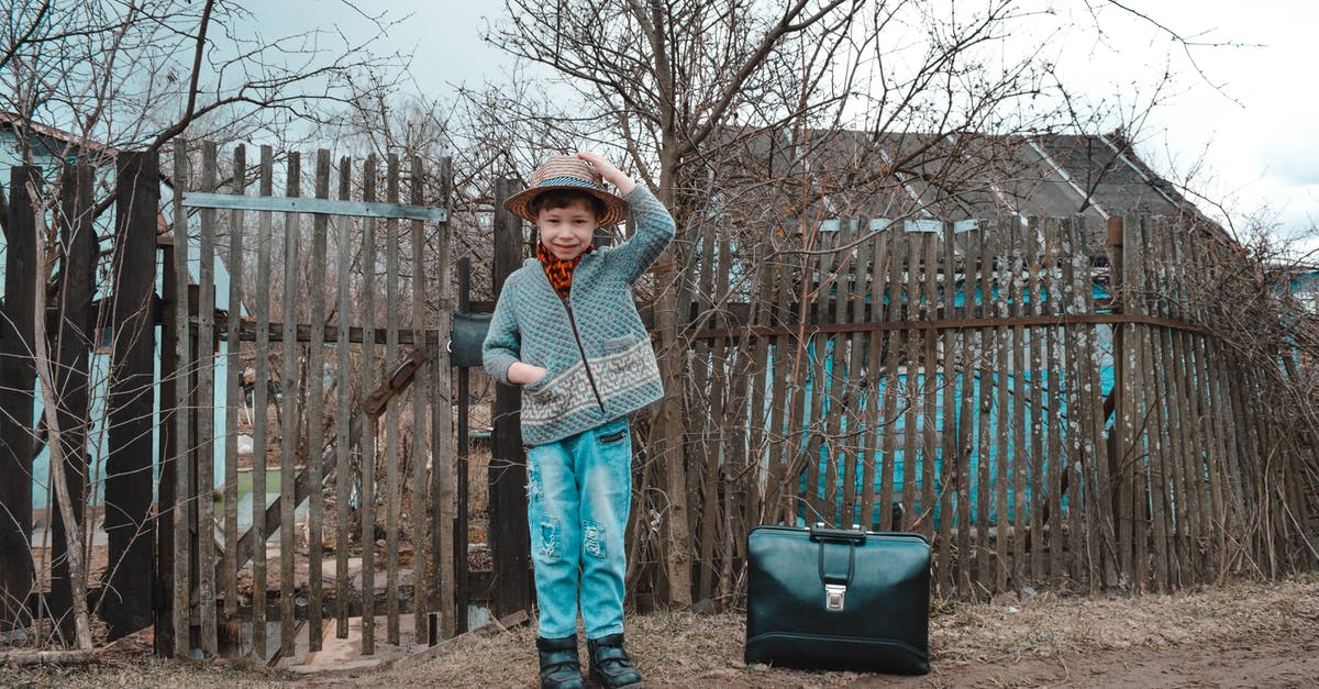 Best strategy for UK visa for a school trip (travelling alone or accomanpied child)? - Full length of cheerful little boy in warm clothes and hat smiling while standing on rural road near suitcase during weekend in countryside Best strategy for UK visa for a school trip (travelling alone or accomanpied child)? - Full length of cheerful little boy in warm clothes and hat smiling while standing on rural road near suitcase during weekend in countryside
