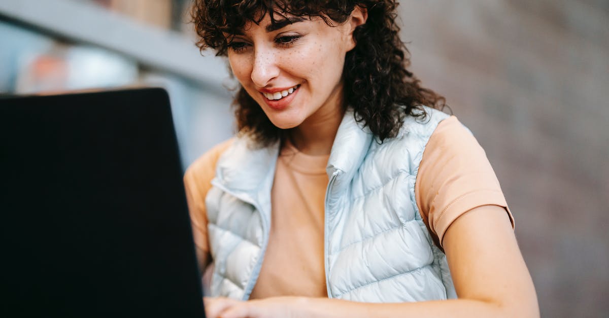Best town to live and work over the Internet in Sicily / Italy [closed] - Crop smiling freelancer working on laptop at cafe table outdoors