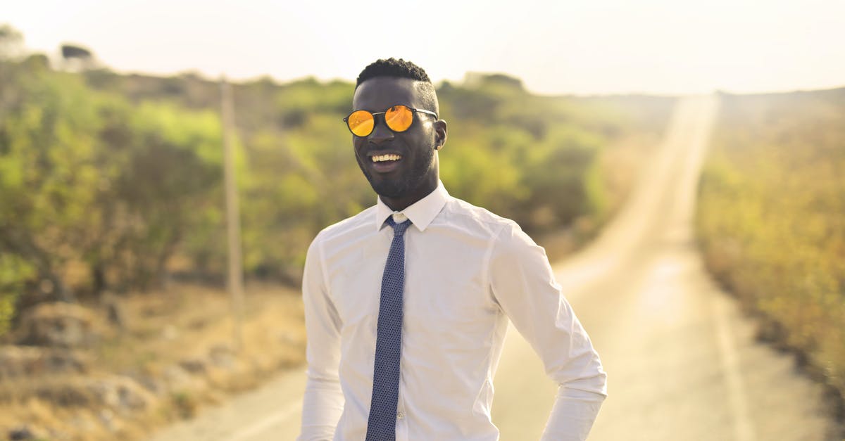 Best way for an American to meet people in France to travel with [closed] - Happy man in formal wear and glasses in countryside