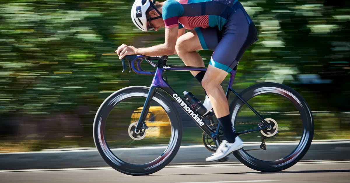 Best way to physically move monetary value around - Bicyclist riding bike on asphalt road Best way to physically move monetary value around - Bicyclist riding bike on asphalt road