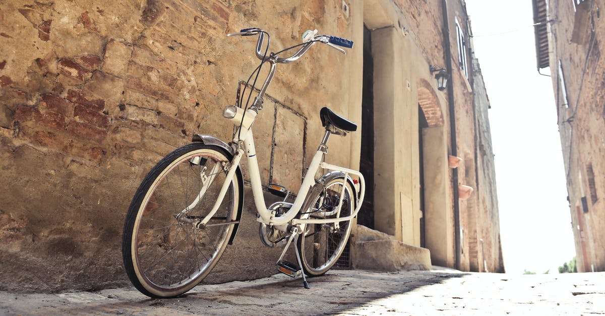 Best way to travel from Palenque to Mexico city by road - Bicycle parked on narrow street against old building with shabby walls in town Best way to travel from Palenque to Mexico city by road - Bicycle parked on narrow street against old building with shabby walls in town