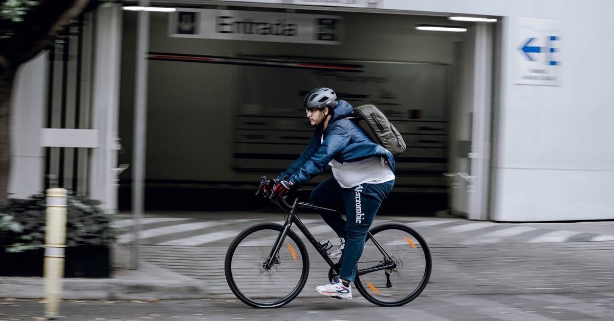 Bicycle helmet and backpack as carry-on in the US? - Man in Blue Jacket Riding on Black Bicycle Bicycle helmet and backpack as carry-on in the US? - Man in Blue Jacket Riding on Black Bicycle
