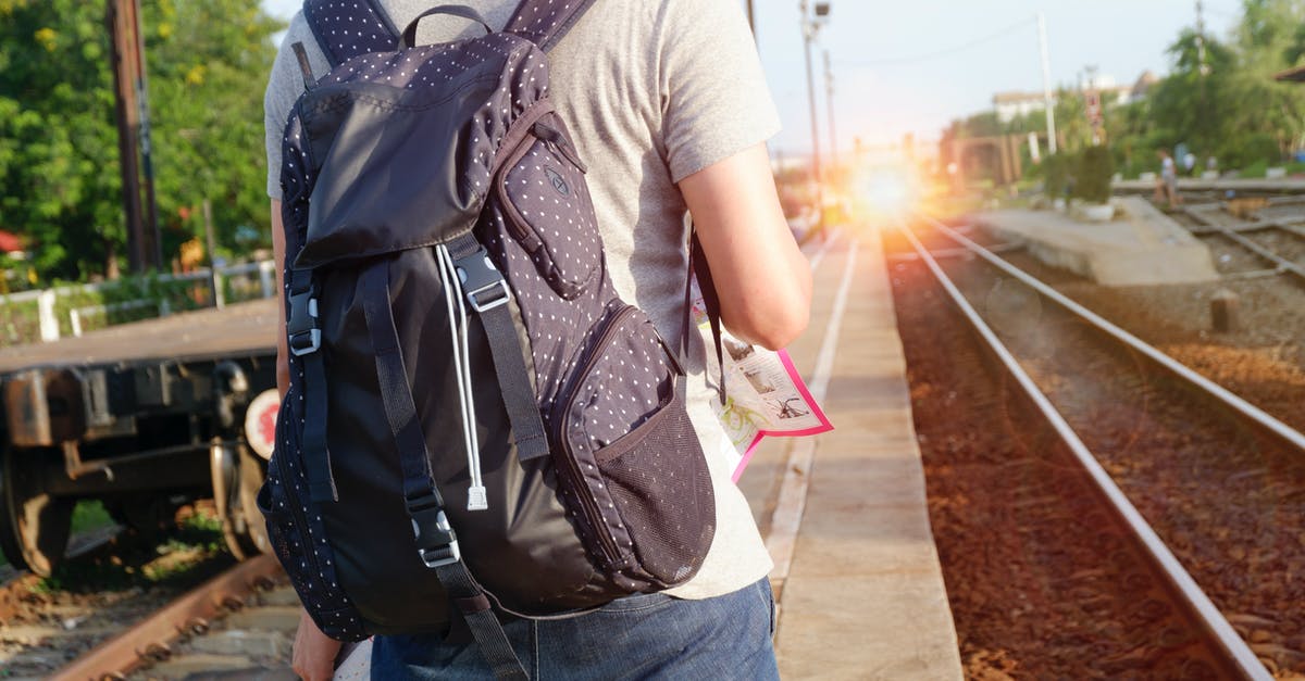 Bipolar sufferer travelling alone - Person in Grey Top With Backpack Waiting for Train Bipolar sufferer travelling alone - Person in Grey Top With Backpack Waiting for Train