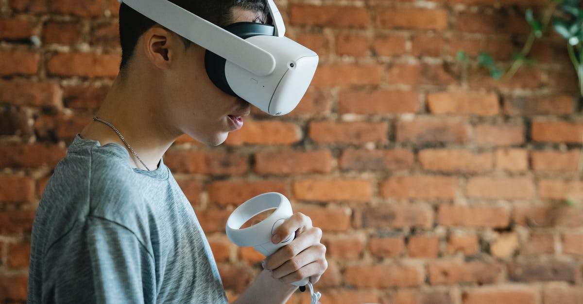 Bluetooth Headset - Do I have anything to worry about if I don't use it during the flight? - Concentrated man using VR device Bluetooth Headset - Do I have anything to worry about if I don't use it during the flight? - Concentrated man using VR device