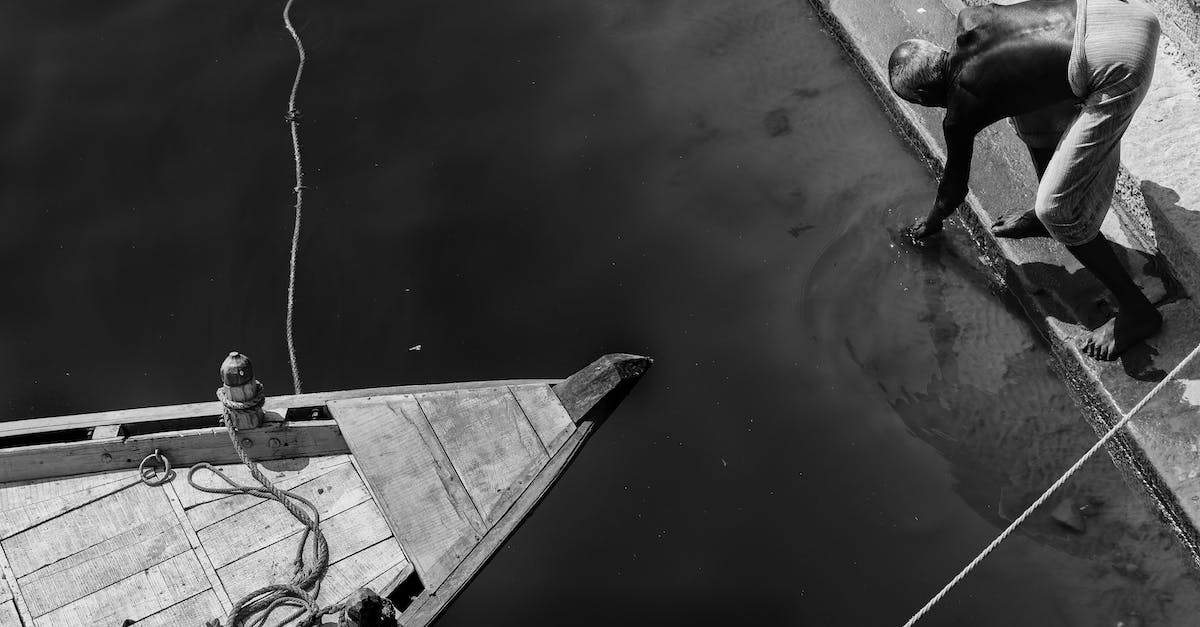 Boat tour on lake Titicaca? - Grayscale Photo of Man in Boat on Water Boat tour on lake Titicaca? - Grayscale Photo of Man in Boat on Water