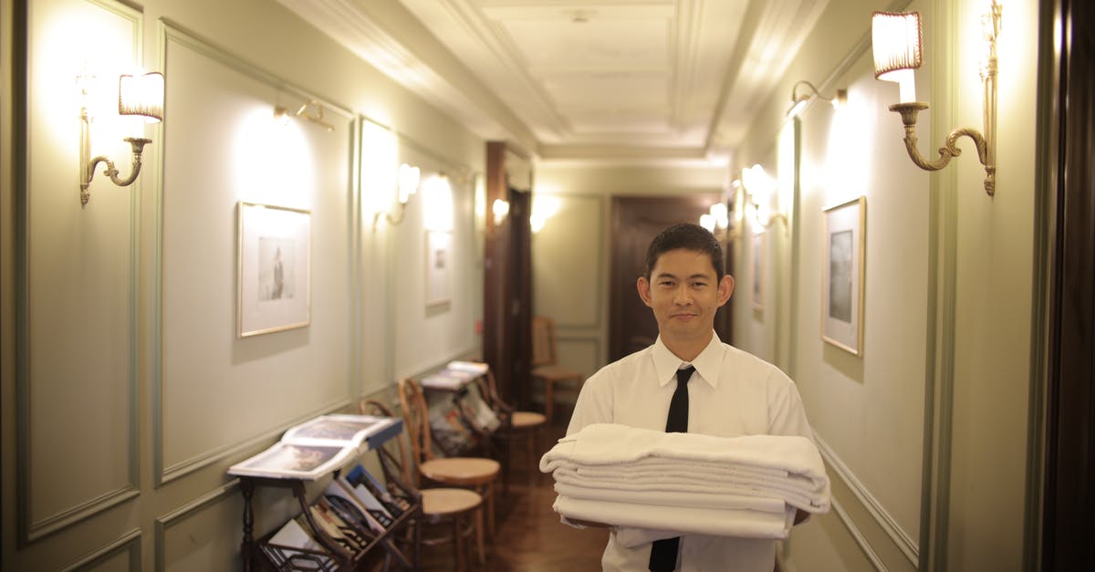 Booked a room 5 months ago, now hotel lowers the price, what can I do? - Man Holding White Linen Ad White Towel Booked a room 5 months ago, now hotel lowers the price, what can I do? - Man Holding White Linen Ad White Towel