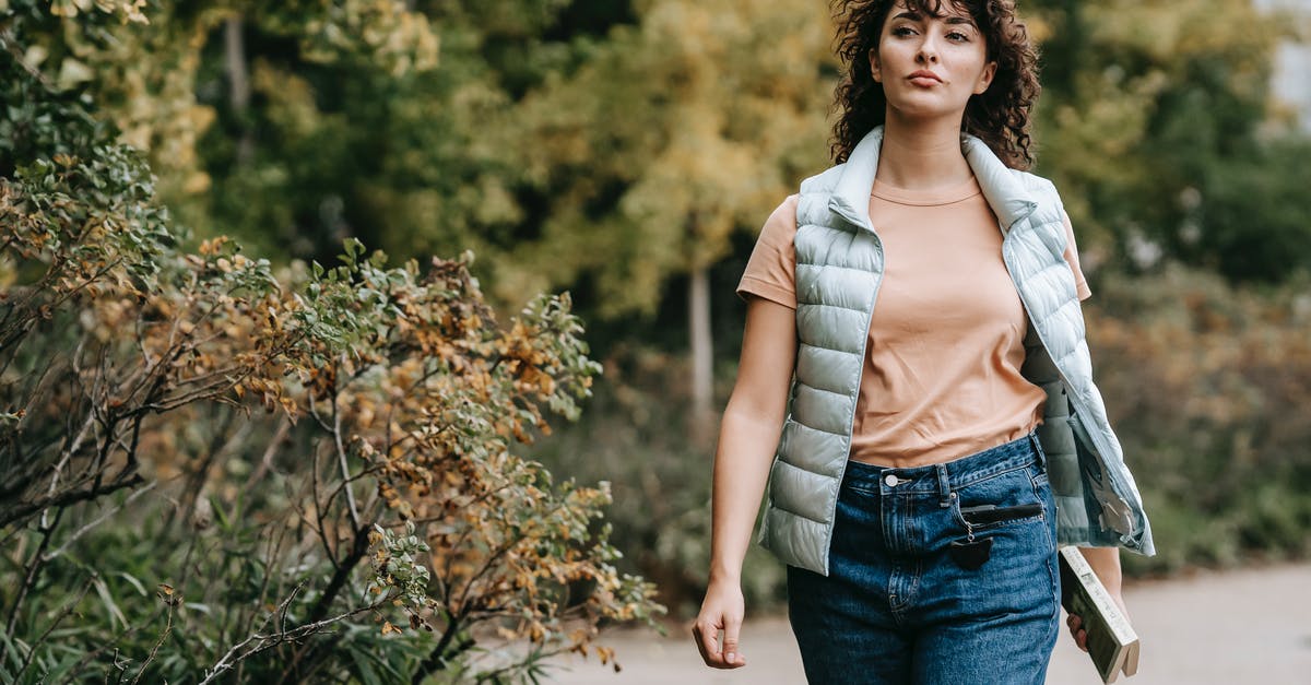 Booking 2 ways ticket, not onboard 1 way, consider canceling both? [duplicate] - Pensive woman in casual clothes walking alone on walkway near green trees placed in city park and looking away in daytime