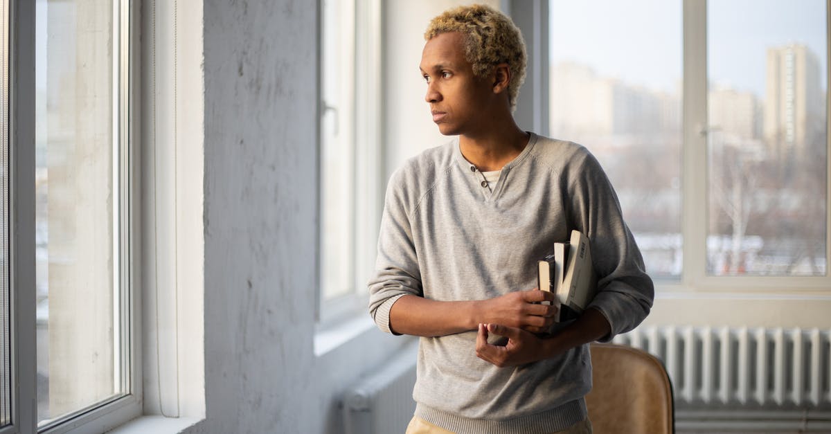 Booking 2 ways ticket, not onboard 1 way, consider canceling both? [duplicate] - Thoughtful African American male in casual outfit with books looking away near windows in university