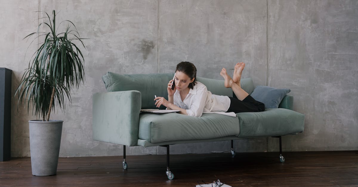 Booking extra economy seat for comfort allowed on transatlantic budget airlines? [closed] - Woman in White Shirt Sitting on Gray Couch