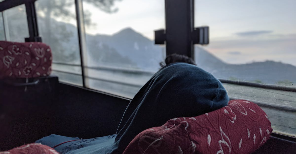 Boquete to Panamá by bus on 3rd March - A Person in Blue Hoodie Relaxing Inside a Transport Vehicle Boquete to Panamá by bus on 3rd March - A Person in Blue Hoodie Relaxing Inside a Transport Vehicle