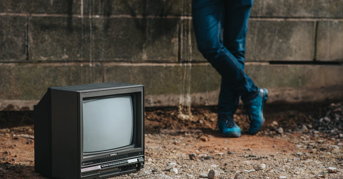 Border crossing on Curonian Spit - Crop person standing near fence and old TV Border crossing on Curonian Spit - Crop person standing near fence and old TV