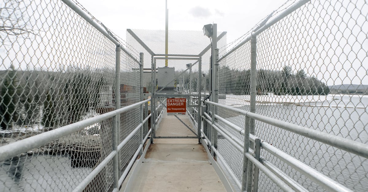 Border guards didn't cancel the stamp, when I went to the wrong gate [closed] - Metal fences on bridge near sea