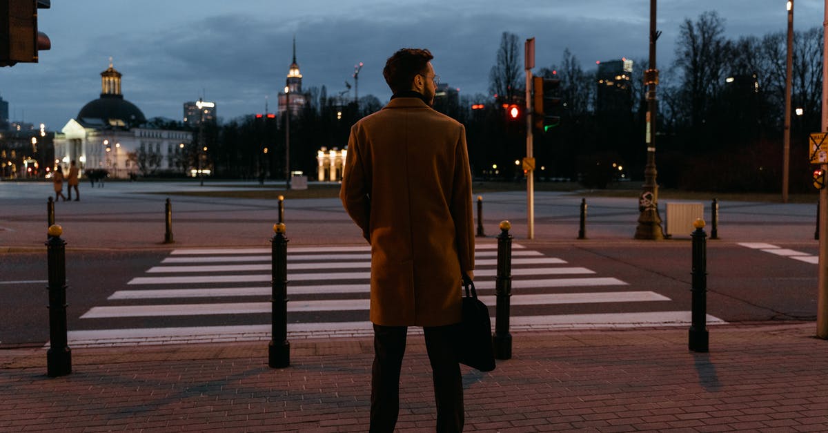 Boston to Europe and back, mixed fare? - Man Wearing Brown Coat Standing on the Street Boston to Europe and back, mixed fare? - Man Wearing Brown Coat Standing on the Street