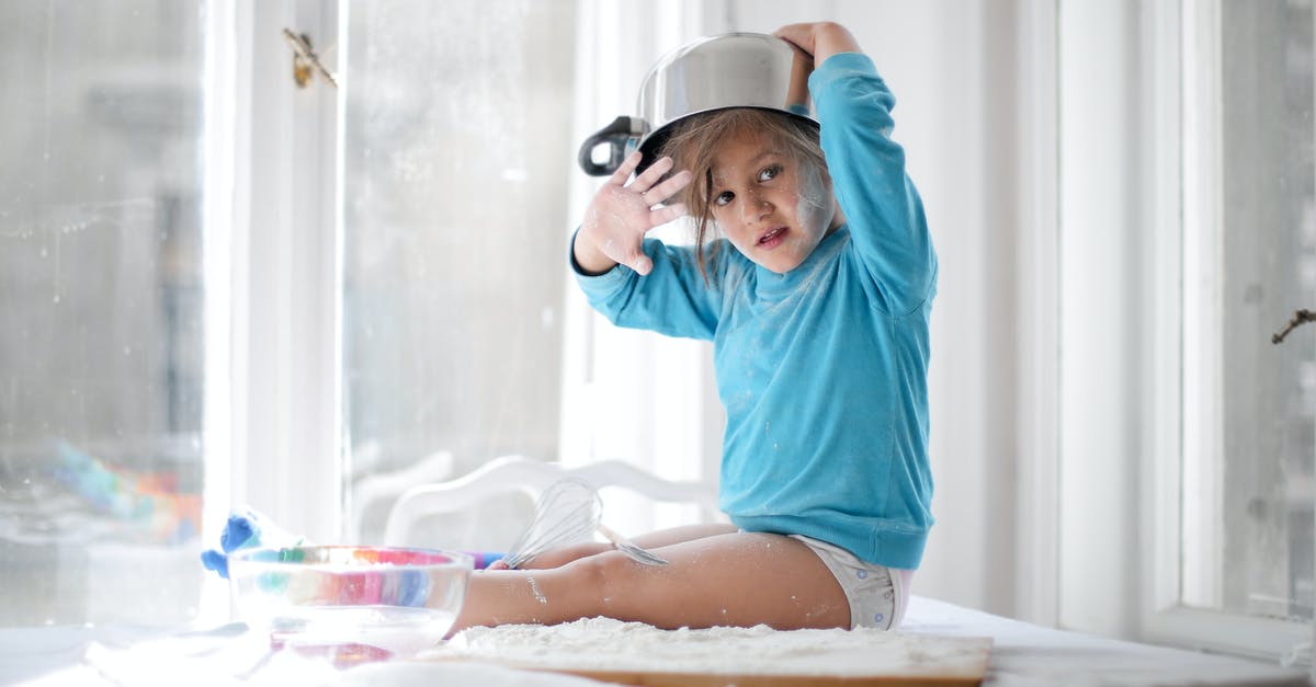 Bring baby food through TSA - Little girl playing with pan and flour in kitchen