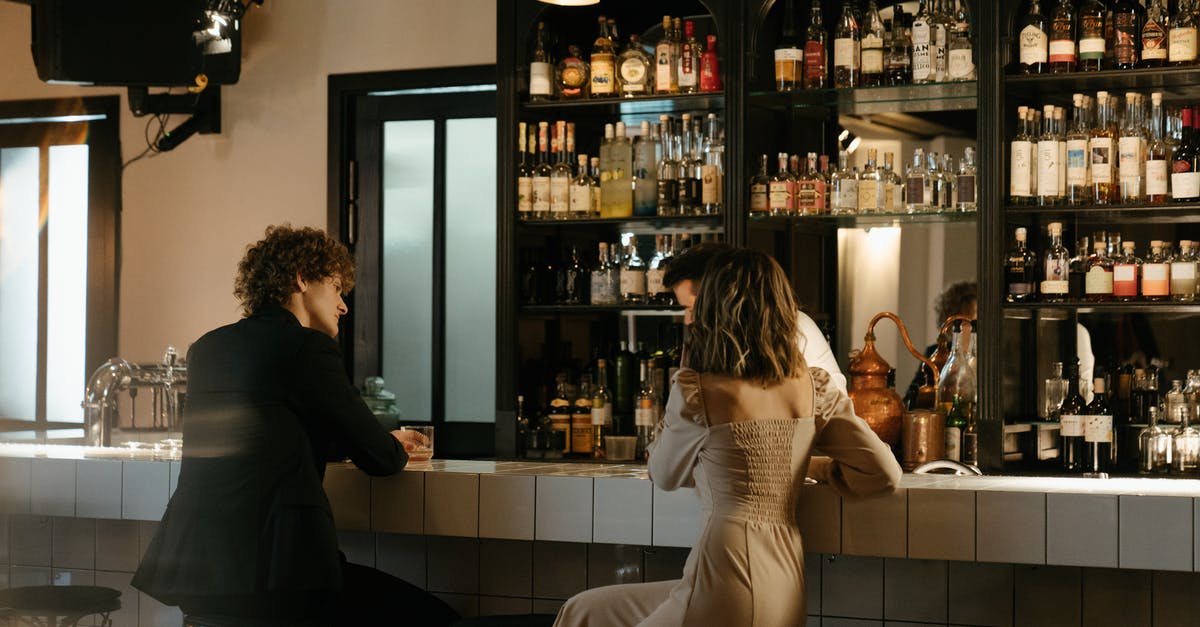 Bringing extra alcohol back to the US: what will it cost? - Man in Black Suit Jacket Standing Beside Woman in White Dress Bringing extra alcohol back to the US: what will it cost? - Man in Black Suit Jacket Standing Beside Woman in White Dress