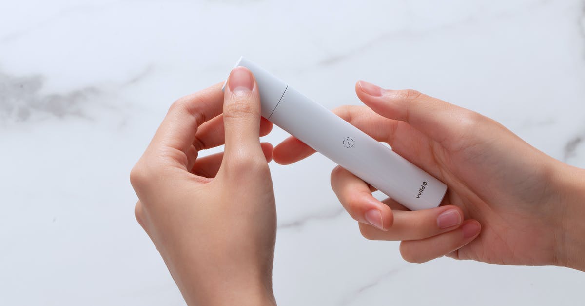 Bringing nicotine e-liquids to Australia - A Person Holding a Vape pod Bringing nicotine e-liquids to Australia - A Person Holding a Vape pod