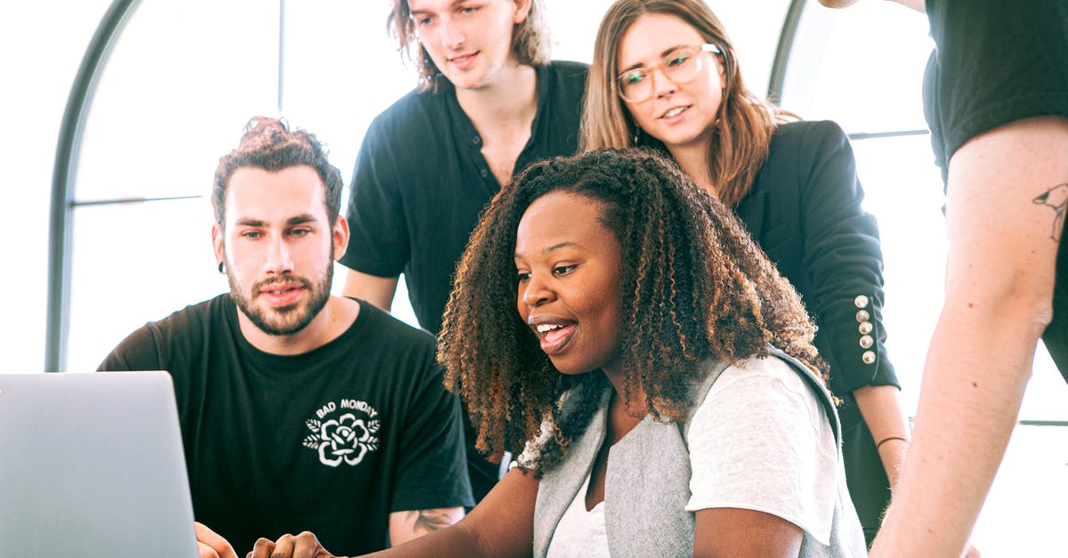 Bringing present to a culture interview meeting in Germany? - Woman Sharing Her Presentation with her Colleagues Bringing present to a culture interview meeting in Germany? - Woman Sharing Her Presentation with her Colleagues