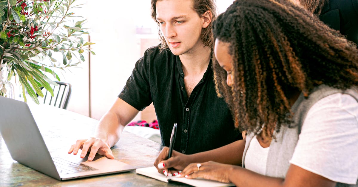 Bringing present to a culture interview meeting in Germany? - Man Working on Laptop while Woman Takes Notes Bringing present to a culture interview meeting in Germany? - Man Working on Laptop while Woman Takes Notes