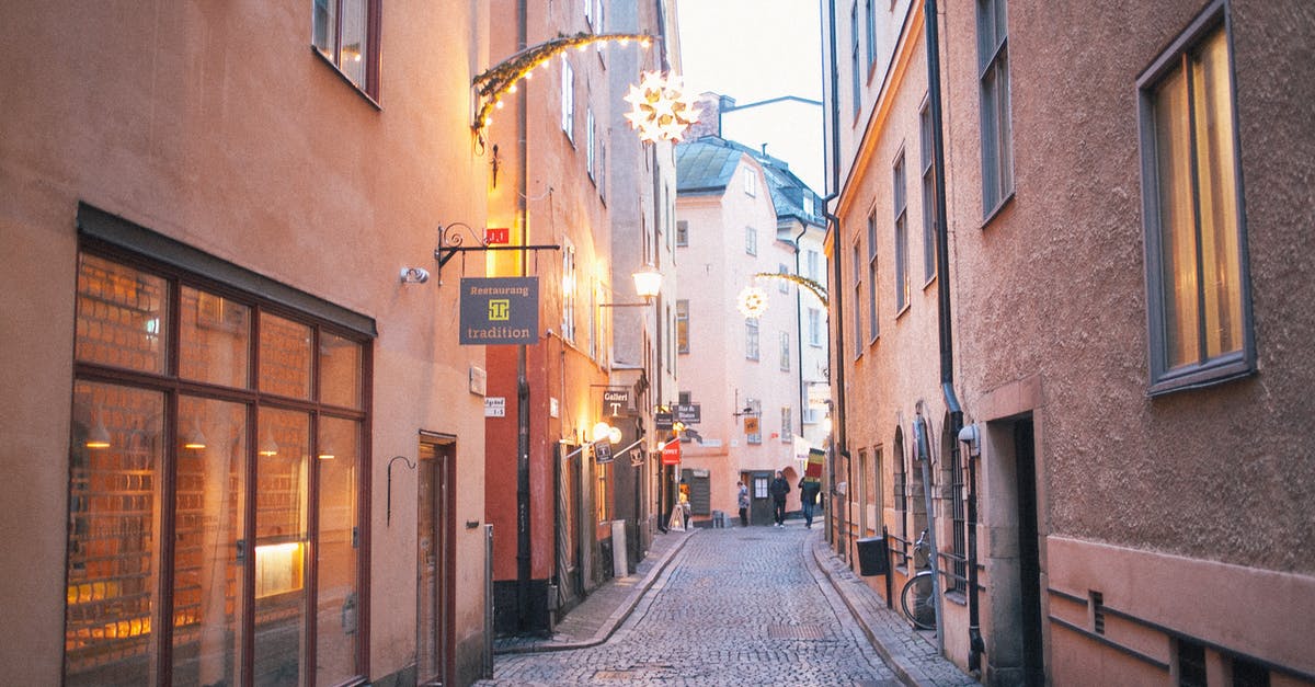 Build the ecologically most sustainable travel route in Europe oneself - Narrow pedestrian street between old residential buildings at twilight