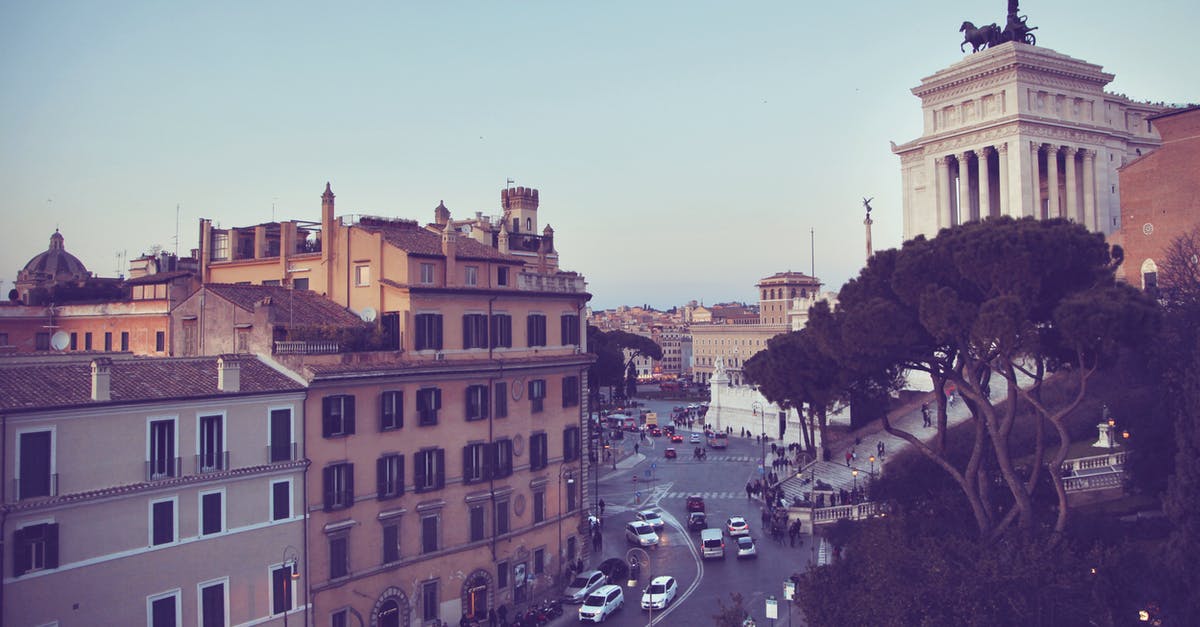 Build the ecologically most sustainable travel route in Europe oneself - Various cars driving on asphalt road near aged residential buildings and famous Victor Emmanuel II Monument against cloudless blue sky in Rome