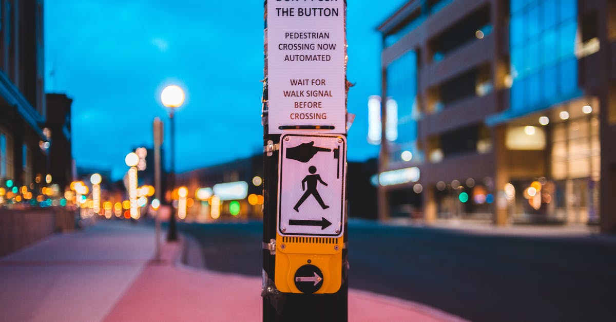 Button for pedestrian traffic lights in Germany - Pedestrian call button on crosswalk in contemporary city in evening Button for pedestrian traffic lights in Germany - Pedestrian call button on crosswalk in contemporary city in evening