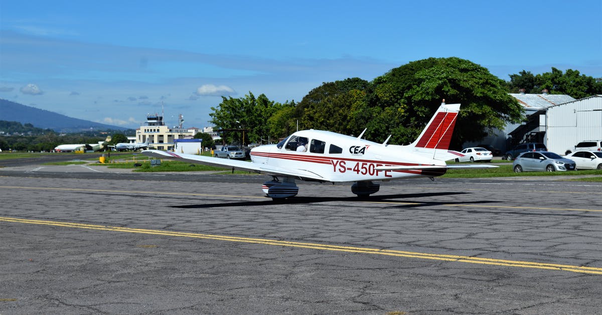 Button suspenders airport firendly [duplicate] - White and Red Passenger Plane on Gray Asphalt Road