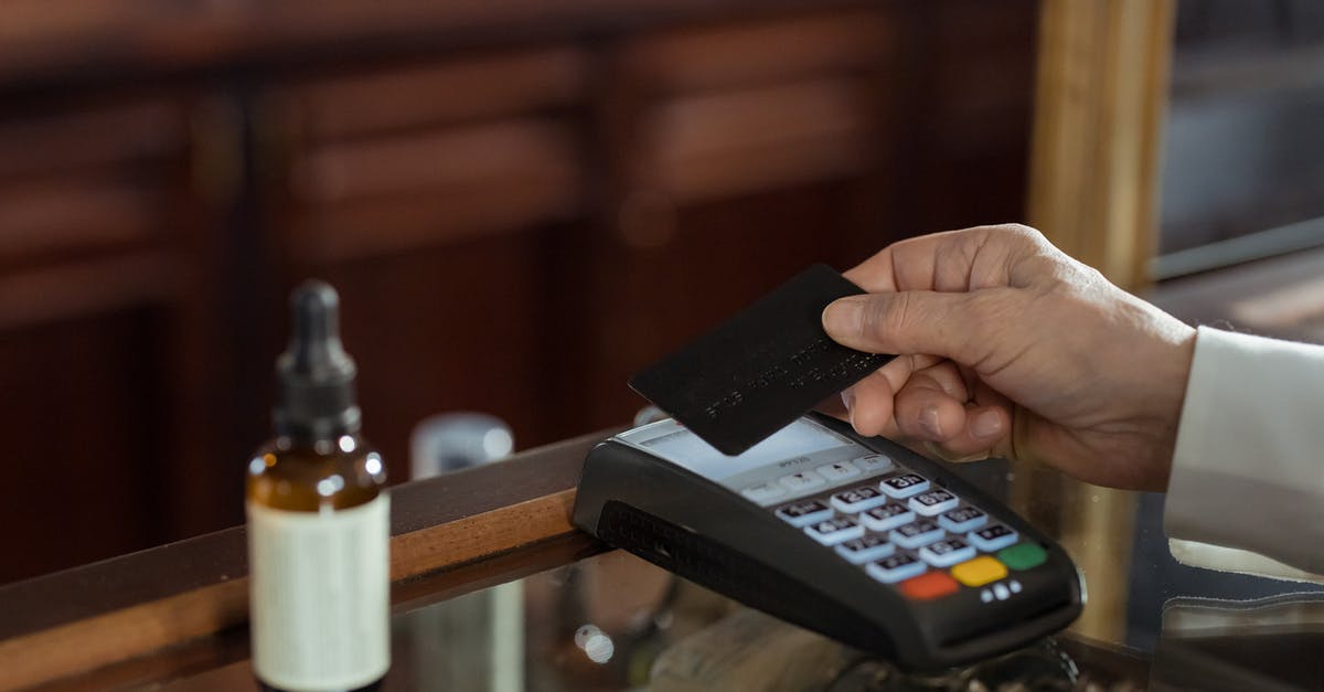 Buying a SIM card on arrival in Amsterdam - Person Holding a Black Card Buying a SIM card on arrival in Amsterdam - Person Holding a Black Card