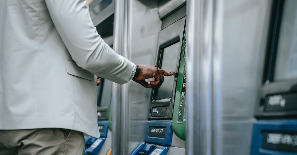 Buying air tickets for 5 people - A Person using a Ticket Machine Buying air tickets for 5 people - A Person using a Ticket Machine