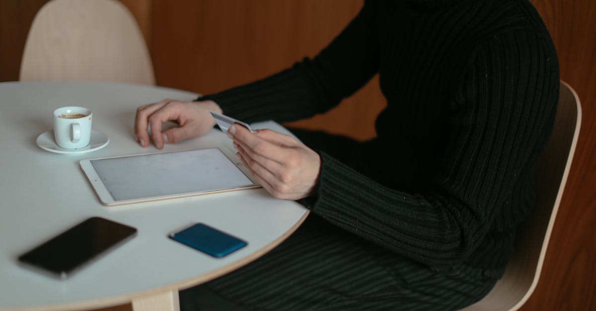 Buying airfare that permits a 'Free Stopover' - Man Shopping Online at Home Using his Tablet and Credit Card Buying airfare that permits a 'Free Stopover' - Man Shopping Online at Home Using his Tablet and Credit Card