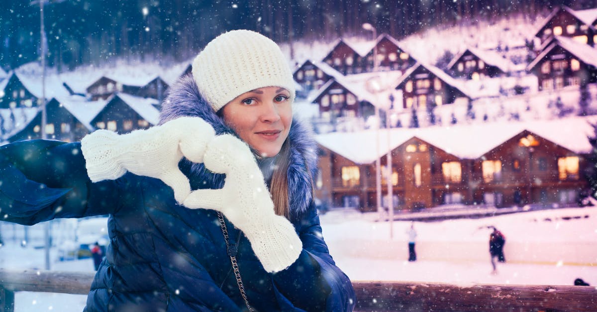 Buying second-hand winter clothes in northern China - Woman Smiling While Leaning on Railings Buying second-hand winter clothes in northern China - Woman Smiling While Leaning on Railings
