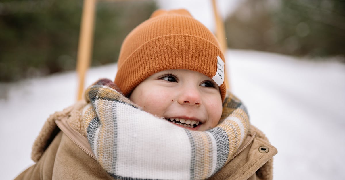Buying second-hand winter clothes in northern China - Baby in Brown Coat Wearing Orange Knit Cap Buying second-hand winter clothes in northern China - Baby in Brown Coat Wearing Orange Knit Cap