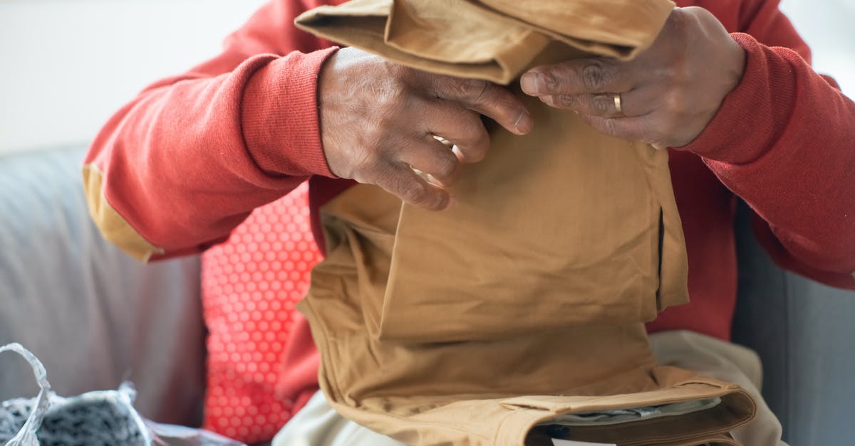 Buying second-hand winter clothes in northern China - Man in Brown Button Up Shirt and Beige Pants Buying second-hand winter clothes in northern China - Man in Brown Button Up Shirt and Beige Pants