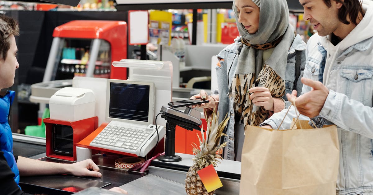 Buying smartphone in US and bringing back to Canada - Couple Buying Groceries at a Supermarket Buying smartphone in US and bringing back to Canada - Couple Buying Groceries at a Supermarket