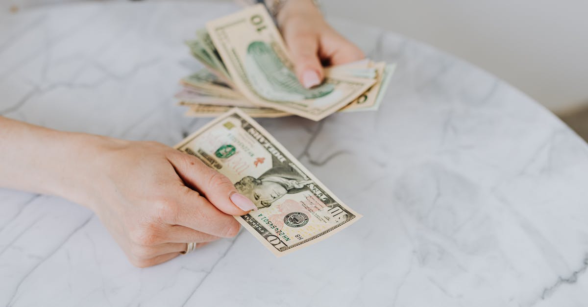 Buying United miles from third-party sites - Person Holding US Dollar Bills Buying United miles from third-party sites - Person Holding US Dollar Bills