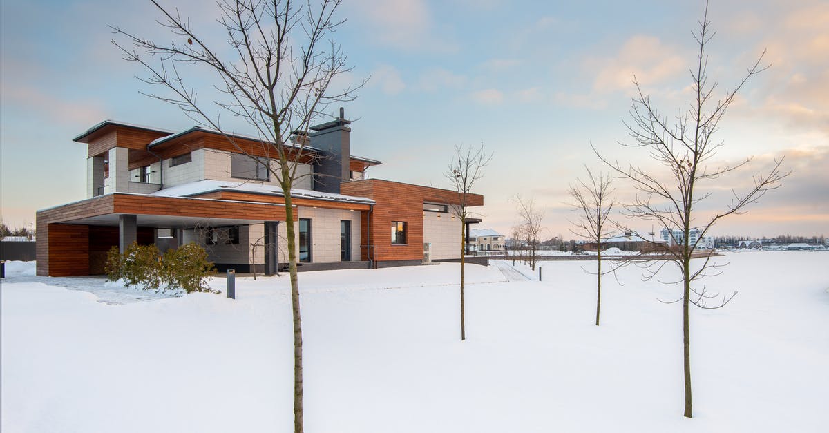 Bypass six month passport-validity rule when already in country - Exterior design of new residential two storey house with modern stone and wooden facade and spacious yard located in suburban area in wintertime Bypass six month passport-validity rule when already in country - Exterior design of new residential two storey house with modern stone and wooden facade and spacious yard located in suburban area in wintertime