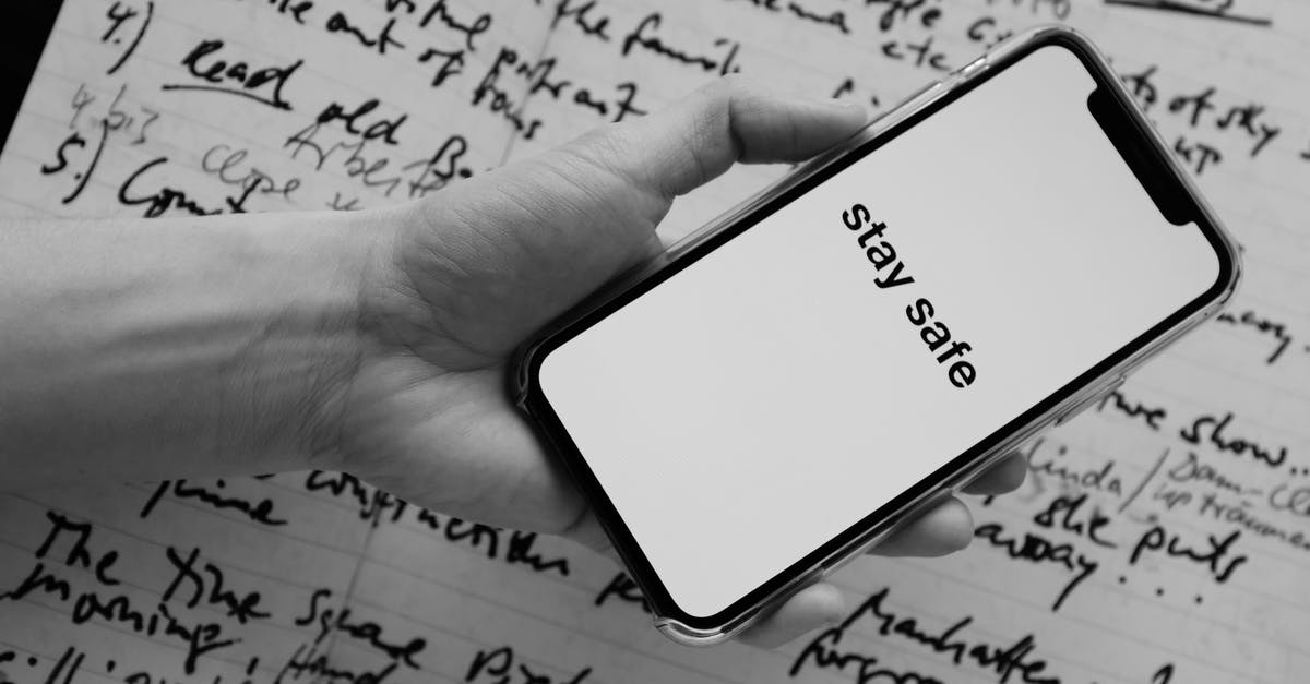 Call local emergency number using a foreign mobile number - Crop unrecognizable person showing smartphone screen with STAY SAFE inscription Call local emergency number using a foreign mobile number - Crop unrecognizable person showing smartphone screen with STAY SAFE inscription