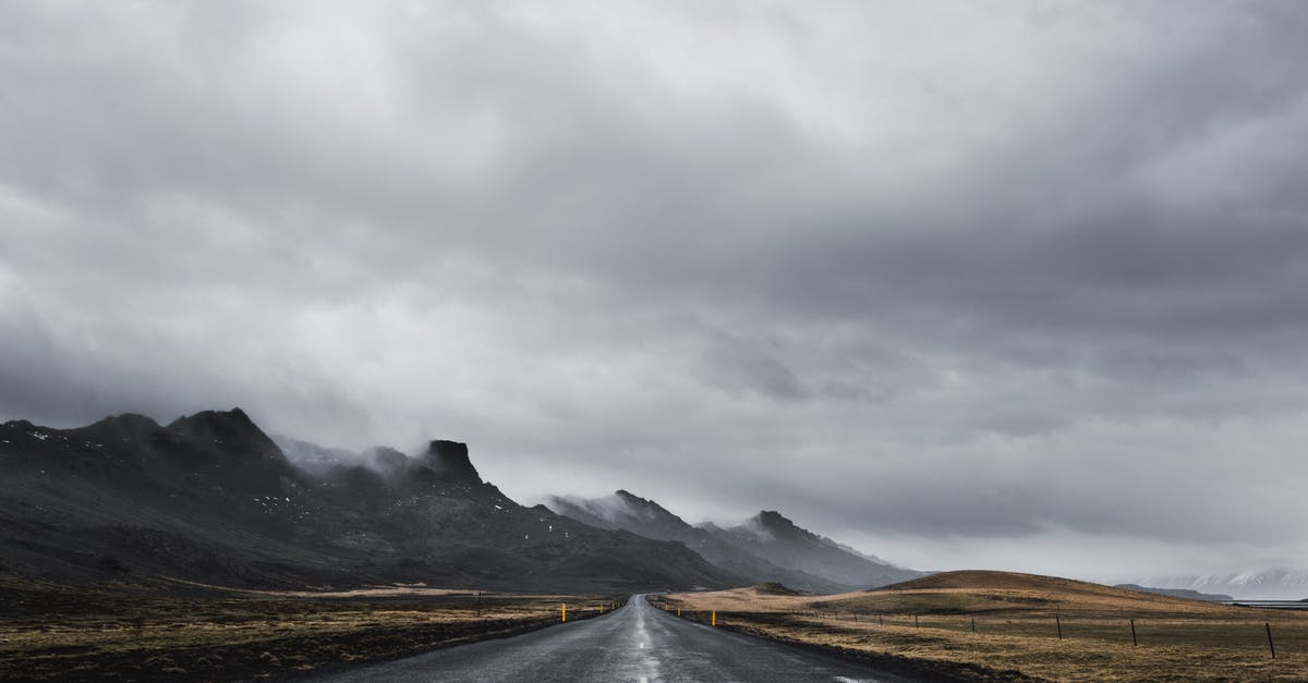 Camping along ring road in Iceland - Gray Asphalt Road Near Mountain Under White Cloudy Sky Camping along ring road in Iceland - Gray Asphalt Road Near Mountain Under White Cloudy Sky