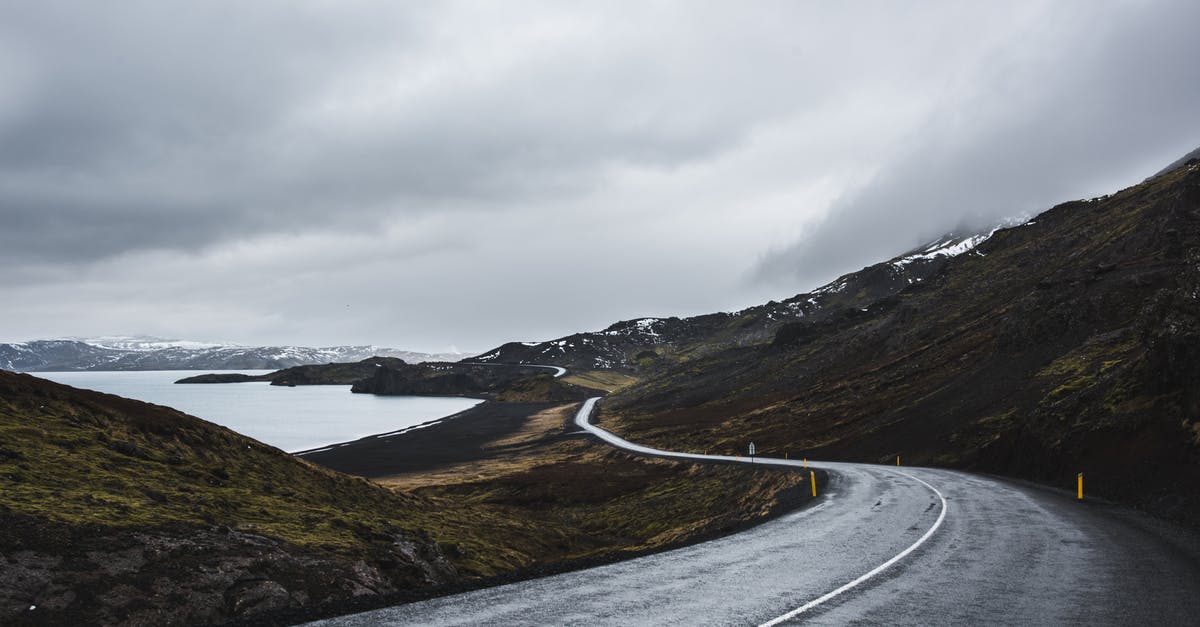 Camping along ring road in Iceland - Gray Concrete Road Near Mountain Under White Clouds Camping along ring road in Iceland - Gray Concrete Road Near Mountain Under White Clouds