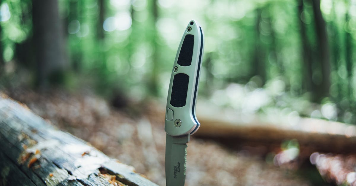 Camping Equipment for Kruger - A Silver Hunting Jack Knife on the Wood Camping Equipment for Kruger - A Silver Hunting Jack Knife on the Wood