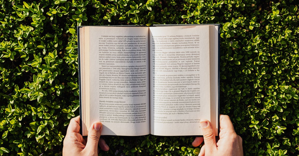 Can 180 days Spanish student visa holder depart from another Schengen state? [duplicate] - Overhead view of crop unrecognizable person reading book on fresh green park lawn in bright sunlight in summer