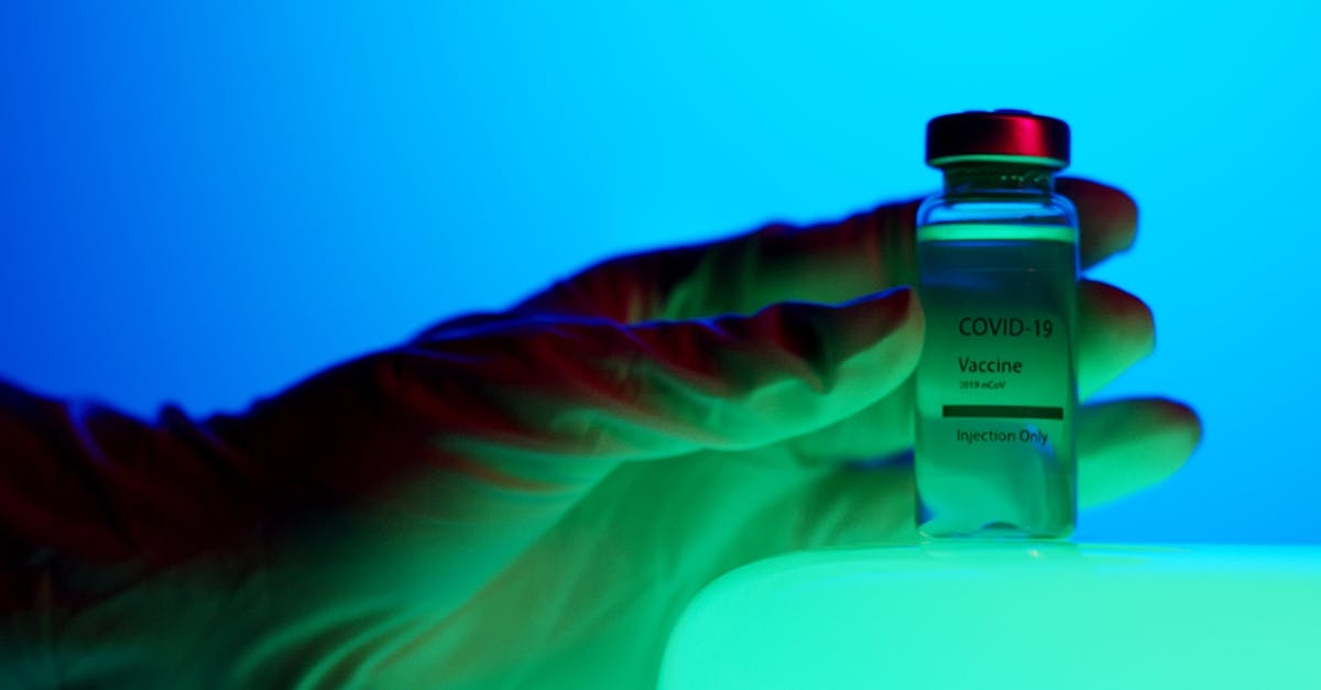 Can 2019-20 coronavirus pandemic be a reason for refusal for my Schengen visa application? [closed] - Close-Up View of a Person Holding a Vaccine Vial