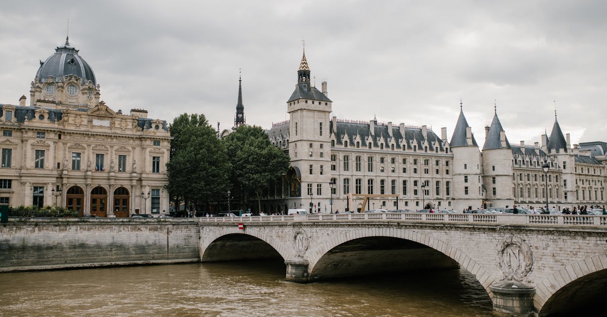 Can a British/Mauritius Dual National use a Mauritius passport to go to Paris and Back - Aged stone bridge crossing river with architectural monument Conciergerie castle located in Paris under cloudy sky Can a British/Mauritius Dual National use a Mauritius passport to go to Paris and Back - Aged stone bridge crossing river with architectural monument Conciergerie castle located in Paris under cloudy sky