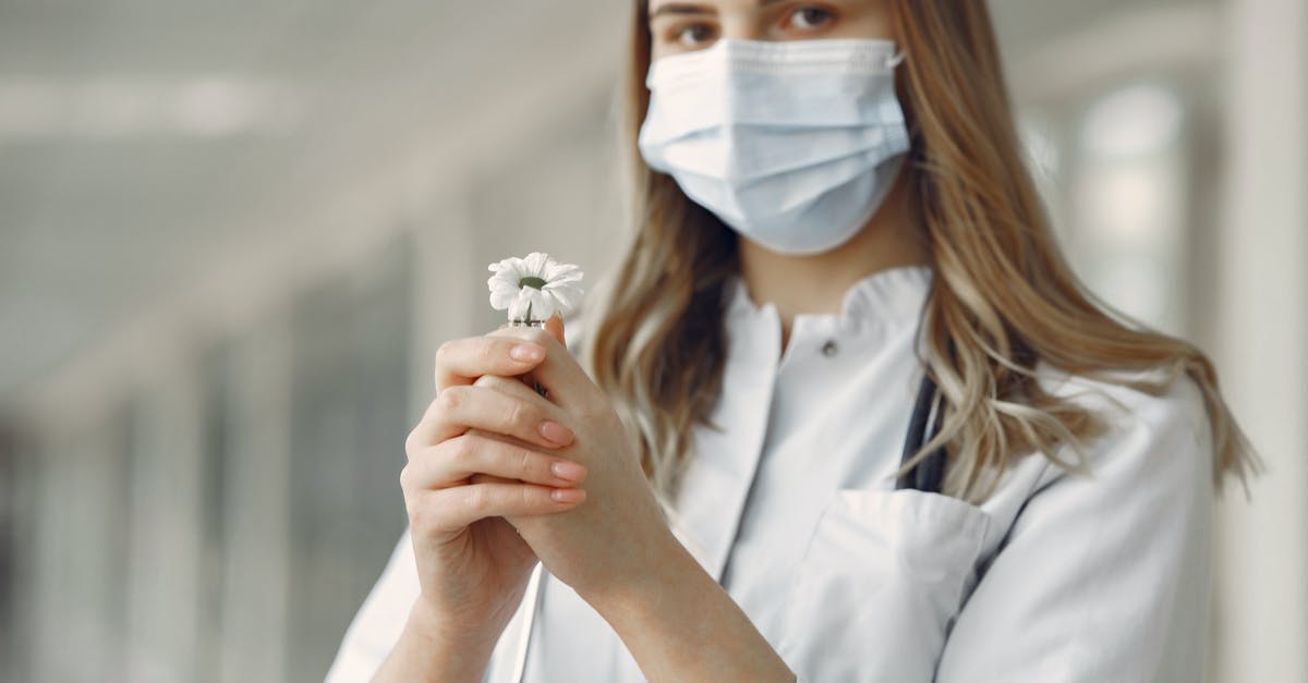 Can a D.O. sign the medical certificate for a student visa at the Chicago consulate? [closed] - Woman in White Button Up Shirt With White Face Mask Holding White Flower