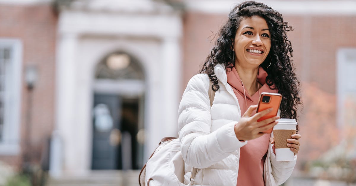Can a F1 student go to Dominican Republic? - Cheerful young ethnic female student with long curly hair in casual clothes and backpack smiling and looking away while using mobile phone standing in campus with takeaway coffee Can a F1 student go to Dominican Republic? - Cheerful young ethnic female student with long curly hair in casual clothes and backpack smiling and looking away while using mobile phone standing in campus with takeaway coffee