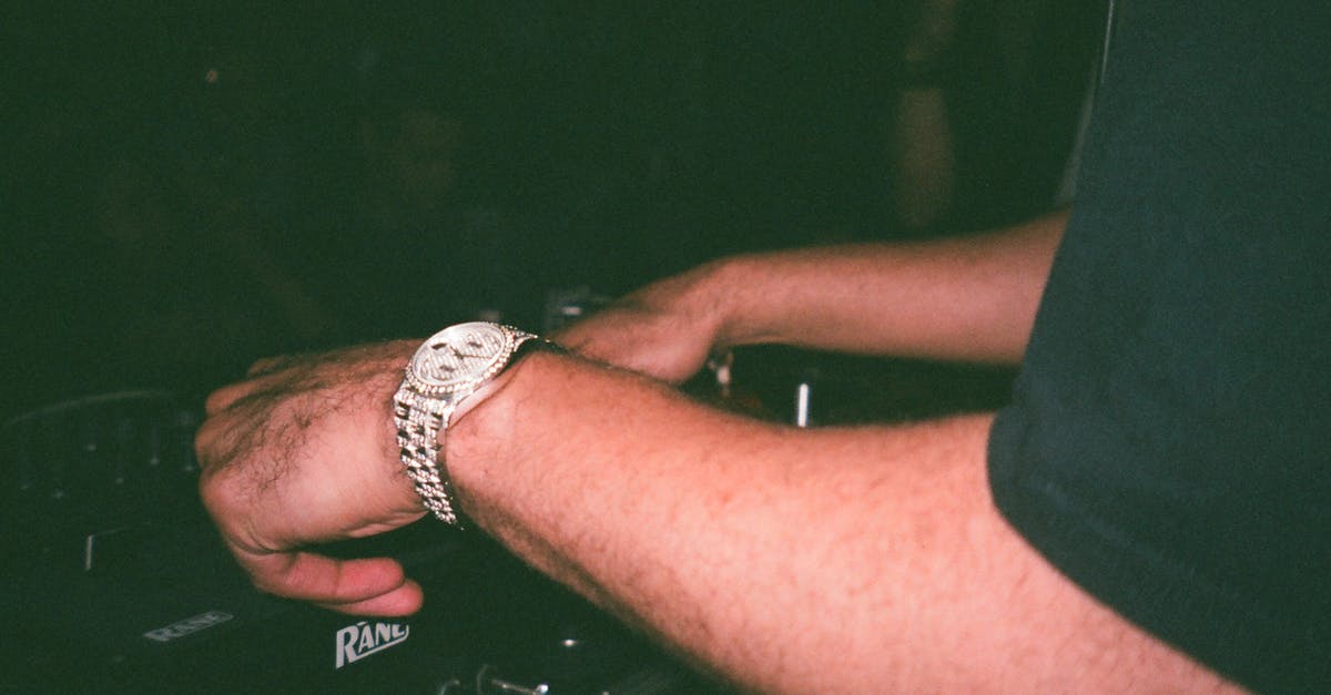 Can a musician bring his used electronic organ to Indonesia [closed] - Close-Up Photo of Person Using Dj Mixer
