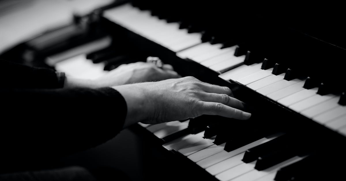 Can a musician bring his used electronic organ to Indonesia [closed] - Person Playing Musical Organ Grayscale Photo