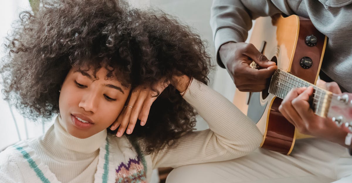 Can a musician missing their instrument at home visit music shops purely to play in-store, not to buy? [closed] - Thoughtful black girlfriend listening boyfriend playing guitar